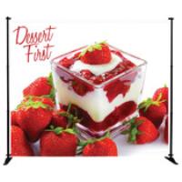 backdrop banner stand with dessert on it that reads "Dessert First"